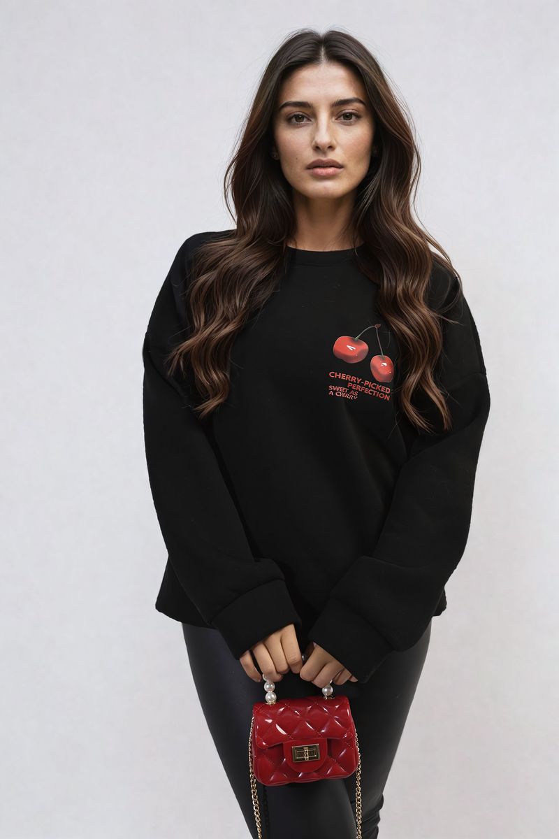 Black oversized knitted jumper with crew neck and small cherry graphic on front