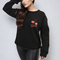 Black oversized knitted jumper with cherry front graphic and long sleeves