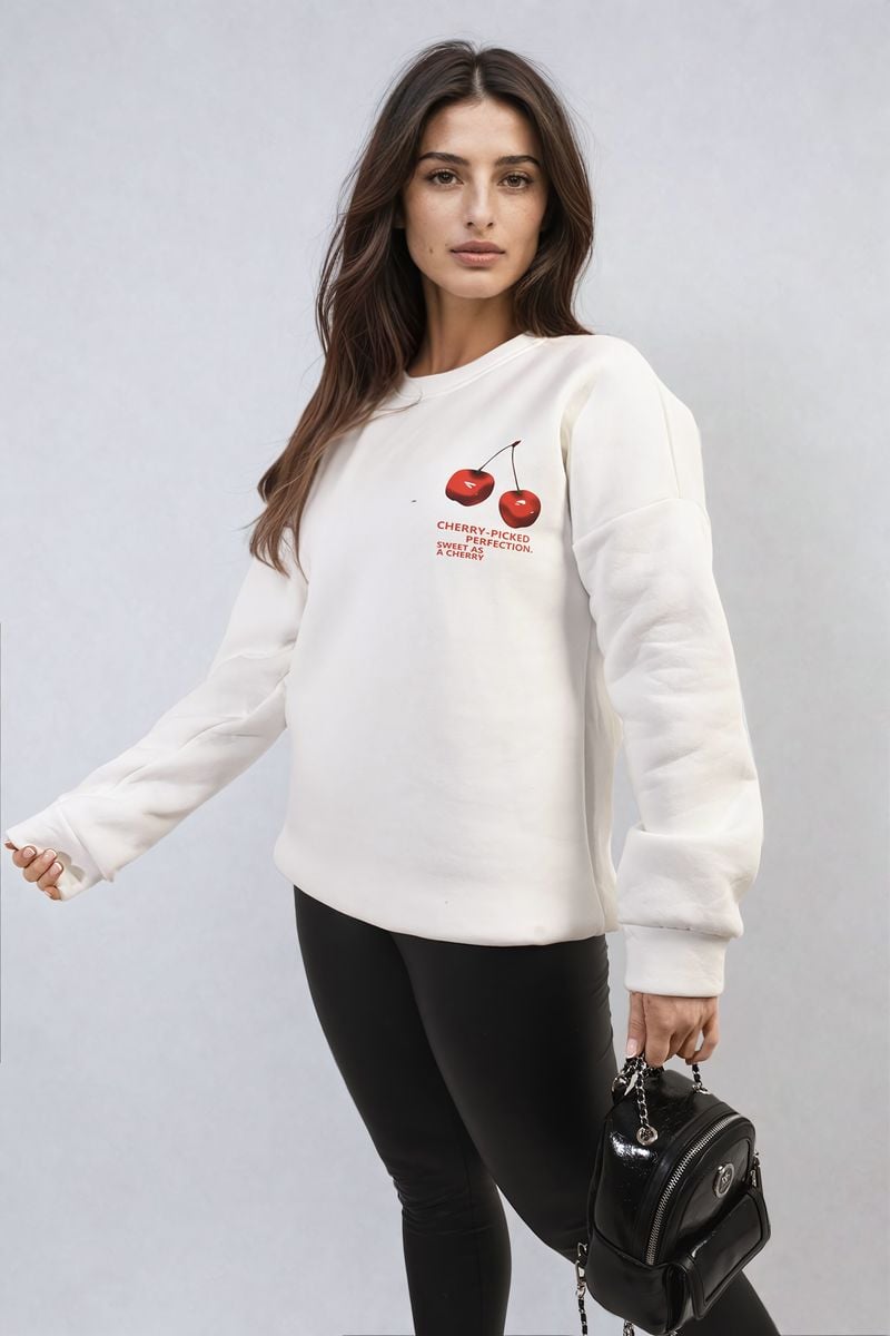 White oversized knitted jumper with crew neck and small cherry graphic on front