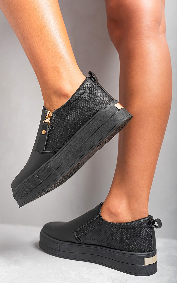 Black textured slip-on trainers with side zipper detail and dark elastic gore