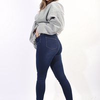 Navy blue high-waisted skinny jeggings with ripped knees and subtle side whiskering