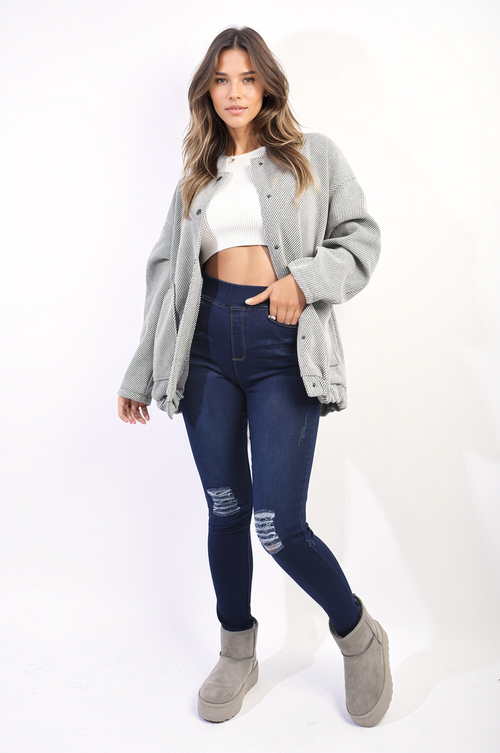 Dark blue high-waisted skinny jeggings with ripped knees and worn, faded areas