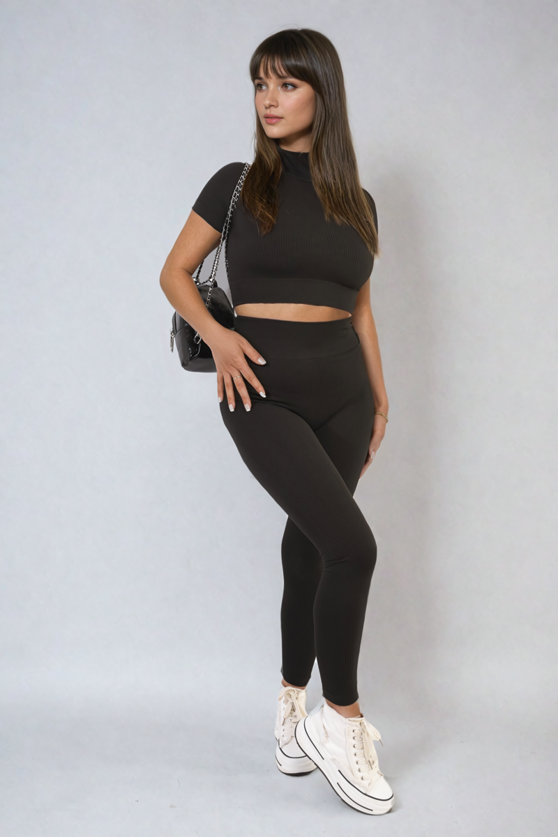 Black ribbed half-zip crop top and high-waist leggings set, fitted two-piece.