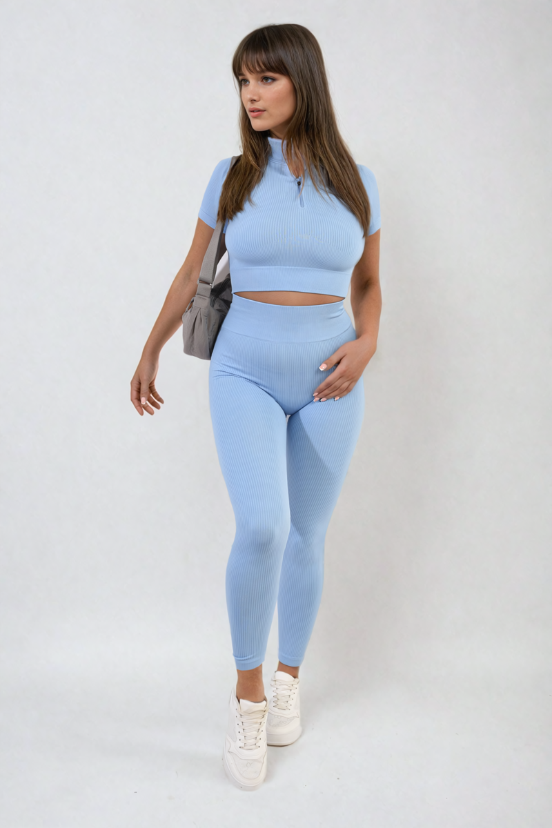 Light blue ribbed half-zip crop top and high-waist leggings set, walking pose