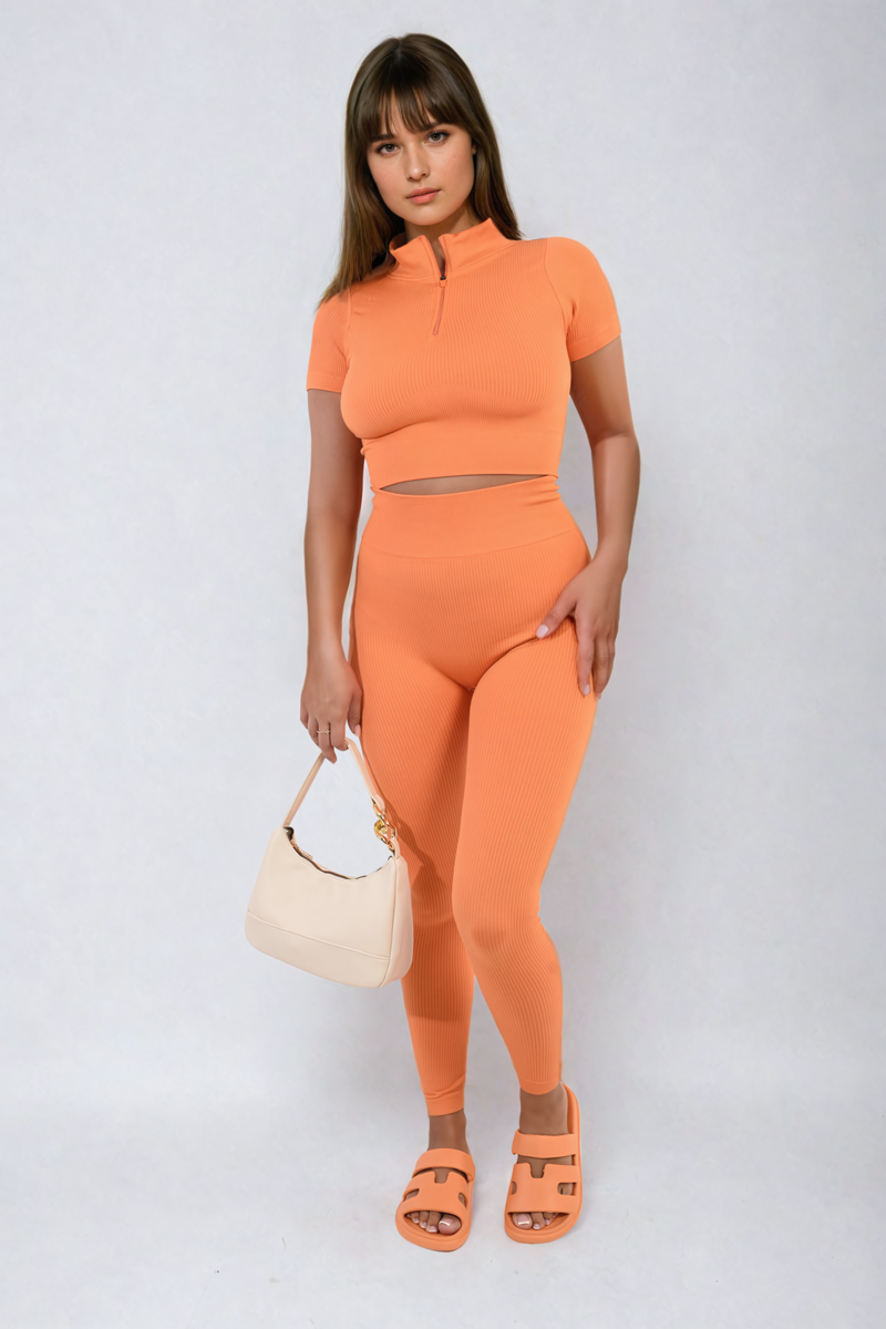 Orange ribbed half-zip crop top and high-waist leggings co-ord set, front view