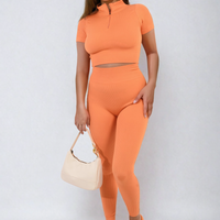 Orange ribbed half-zip crop top and high-waist leggings co-ord set, front view