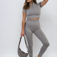 Grey ribbed half-zip crop top and high-waist leggings set, full-body standing