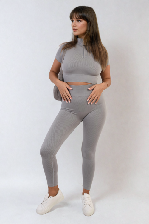 Grey ribbed half-zip crop top and high-waist leggings set, fitted two-piece.