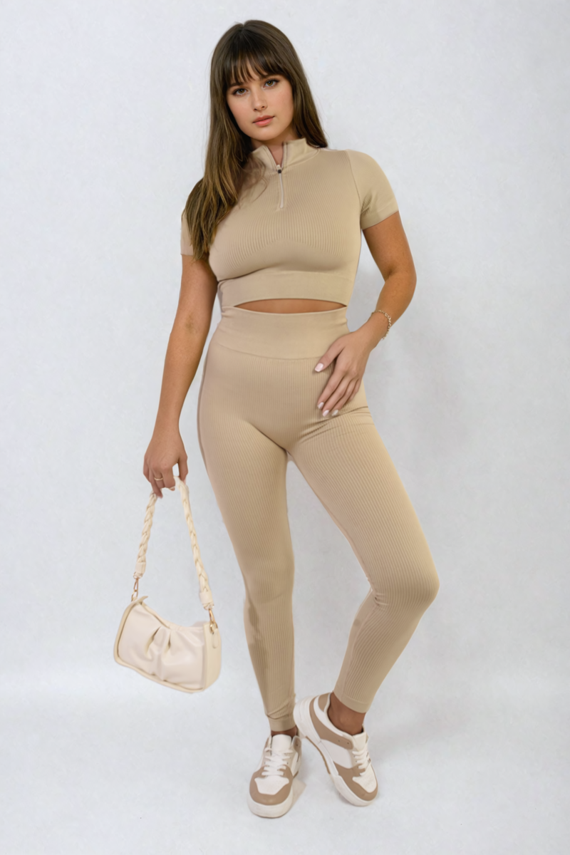 Beige ribbed half-zip crop top and high-waist leggings set, holding white bag