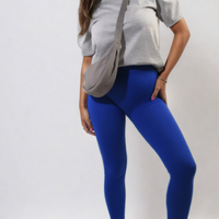 High-waisted royal blue leggings with wide waistband, ankle-length, front stance