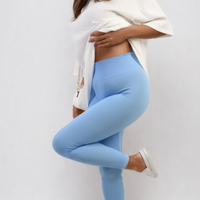 High-waisted light blue leggings with wide waistband, ankle-length, knee-bend pose