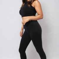 High-waisted black leggings with wide waistband, ankle-length, full-body view