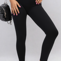 Black high-waisted ankle leggings with wide waistband, ribbed leg texture.
