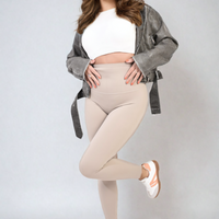 Apricot high-waisted leggings with wide waistband and slim fitted legs, side view