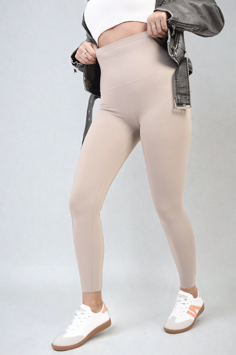 Apricot high-waisted leggings close-up, wide waistband and smooth fitted legs