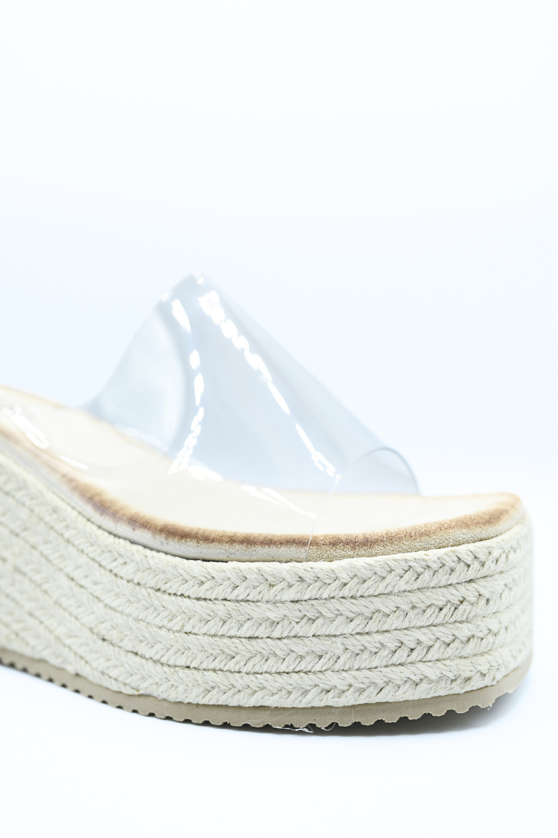 Beige platform wedge sandal with clear toe strap and textured braided midsole