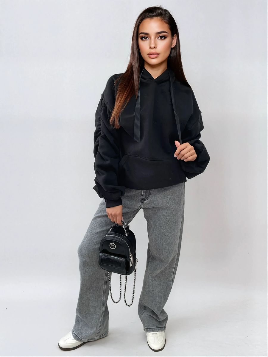 Oversized black hoodie with ruched sleeves, front pouch pocket, and drawstring hood