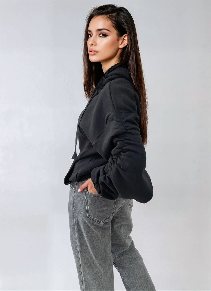 Oversized black hoodie with ruched sleeves, pouch pocket, and drawstring hood