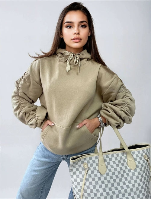 Oat/beige oversized hoodie with drawstring hood, front pouch pocket, and ruched sleeves