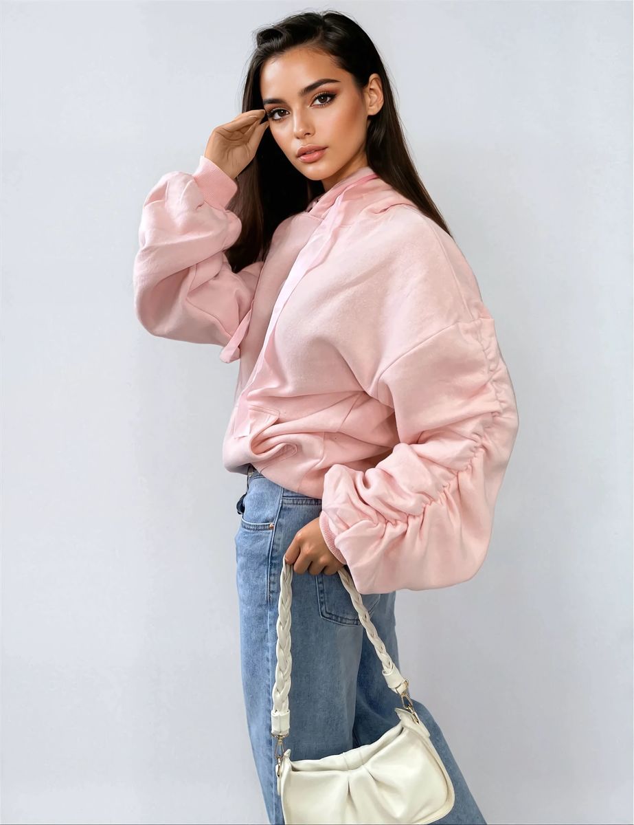 Oversized pink hoodie with ruched sleeves, pouch pocket, and drawstring hood