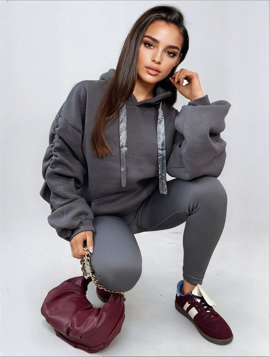 Charcoal gray oversized hoodie with drawstring hood and front pouch pocket, ruched sleeves