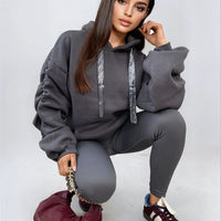 Charcoal gray oversized hoodie with drawstring hood and front pouch pocket, ruched sleeves