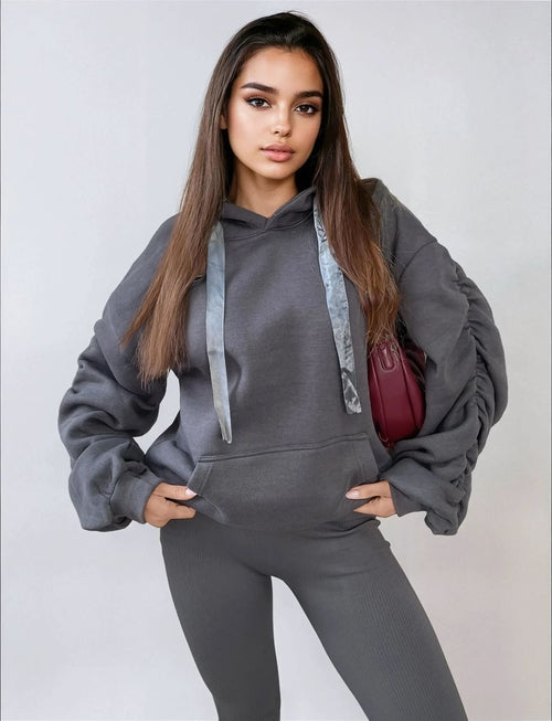 Gray oversized hoodie with drawstring hood, front pouch pocket, and ruched sleeves