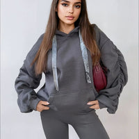 Gray oversized hoodie with drawstring hood, front pouch pocket, and ruched sleeves