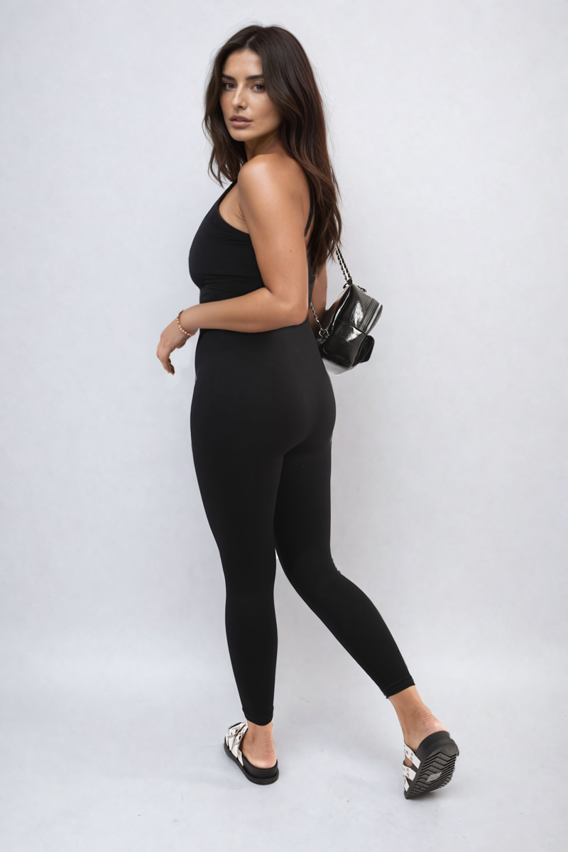 Black bodycon jumpsuit with scoop neck and slim straps, fitted long leggings legs