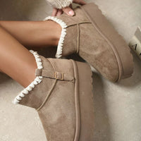 Brown suede ankle boots with faux fur lining, side buckle strap, and chunky platform sole.