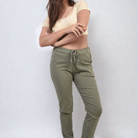 Olive khaki drawstring tapered trousers with side pockets and cuffed ankle hem