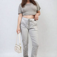 Grey drawstring tapered trousers with side pockets and cuffed ankle hems