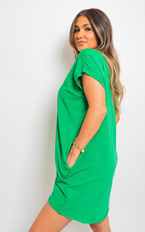 Bright green short-sleeve tunic top with front pockets, loose silhouette.