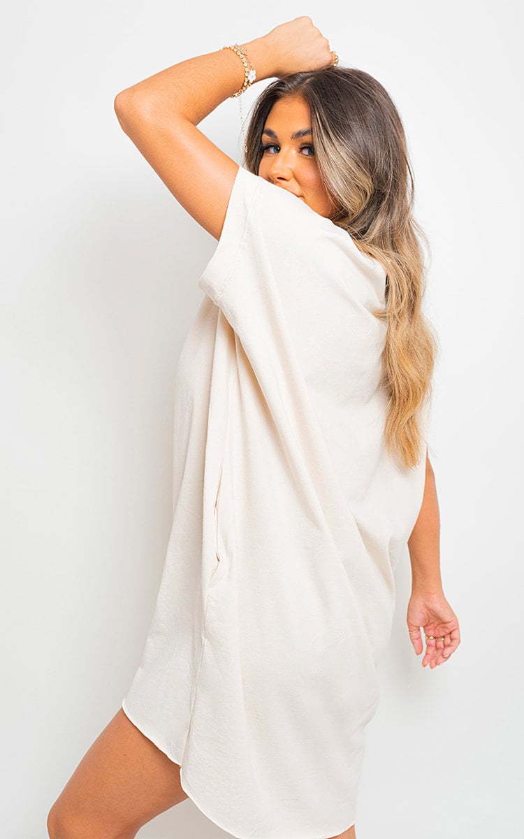 White short-sleeve tunic top with relaxed drape and rounded hem