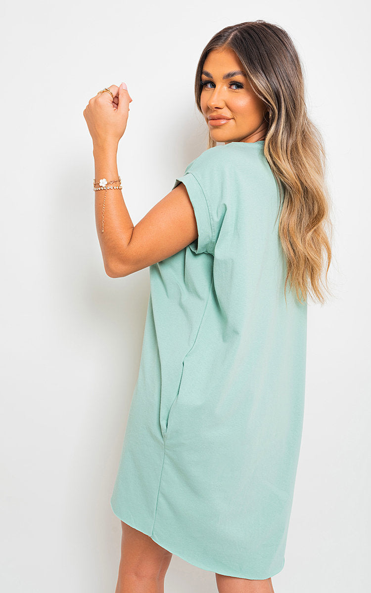 Light blue short-sleeve tunic top with loose drape and crew neckline