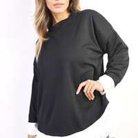 Black oversized dress top with long sleeves and white contrast ruffle hem