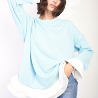 Sky blue oversized dress top with long sleeves and white contrast ruffle hem