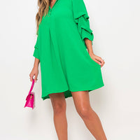 Bright green shirt dress with collar and loose three-quarter sleeves, mini length.