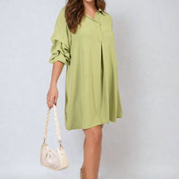 Pale green shirt dress with collar and loose sleeves, mini length.