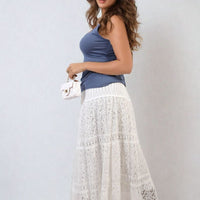Blue tank top with scoop neck and wide shoulder straps, side drape