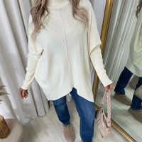 Ivory oversized knitted jumper with rhinestone dot pattern, high neck and long sleeves