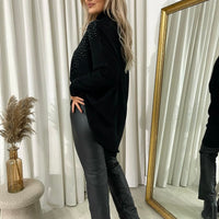 Black knitted jumper with rhinestone-speckled detail and high ribbed neck