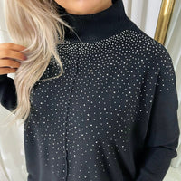 Black knitted jumper close-up with rhinestone-speckled yoke and high ribbed neck