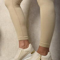Beige platform trainers with side zip, rhinestone panel, and white tread sole