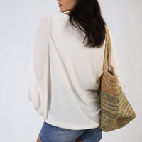 Oversized white round-neck top with draped batwing sleeves