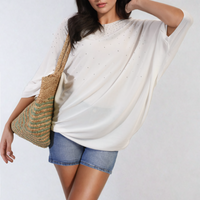 Oversized white round-neck top with studded dot accents on the front