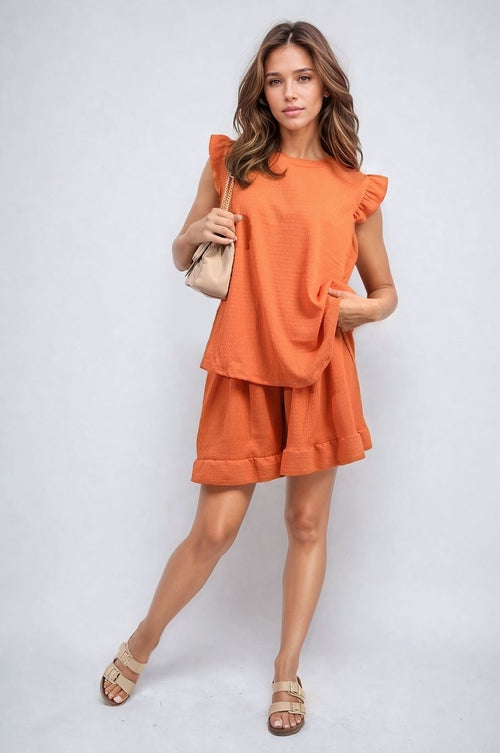 Orange ruffle-trim short-sleeve top and matching shorts set with ruffled shoulders