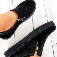 Black slip-on trainer with rhinestone-dotted upper, croc-effect side panel, gold zip detail.