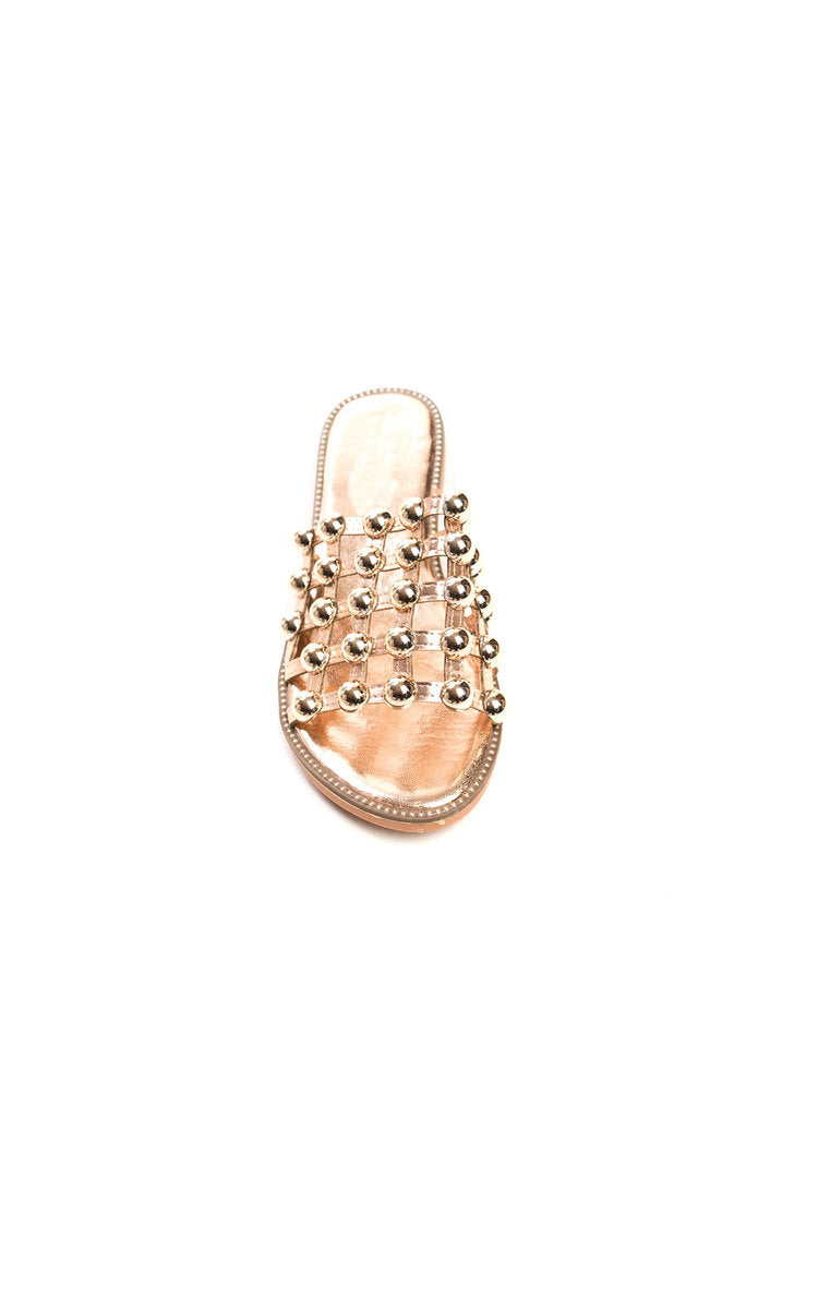 Nude flat slide sandals with studded lattice rhinestone straps, open toe