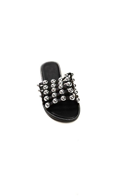 Black flat slide sandals with studded lattice straps and open toe